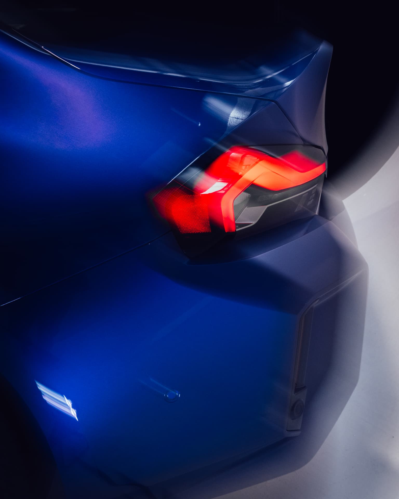 Blue rear bodywork of THE M2 CS with illuminated tail light at IAA 2025