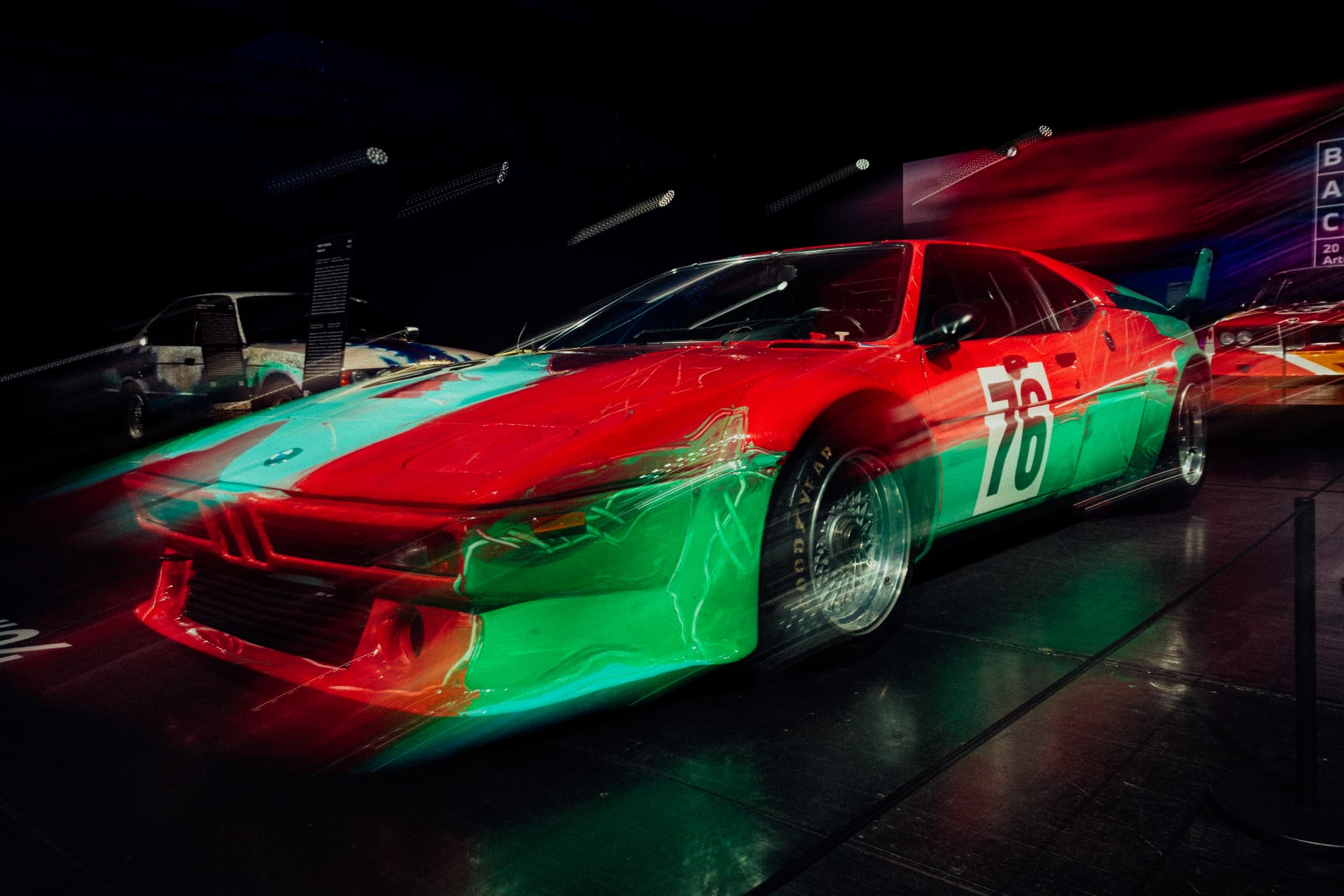 Red and green BMW Art Car number 76 photographed with long-exposure light at BMW Welt