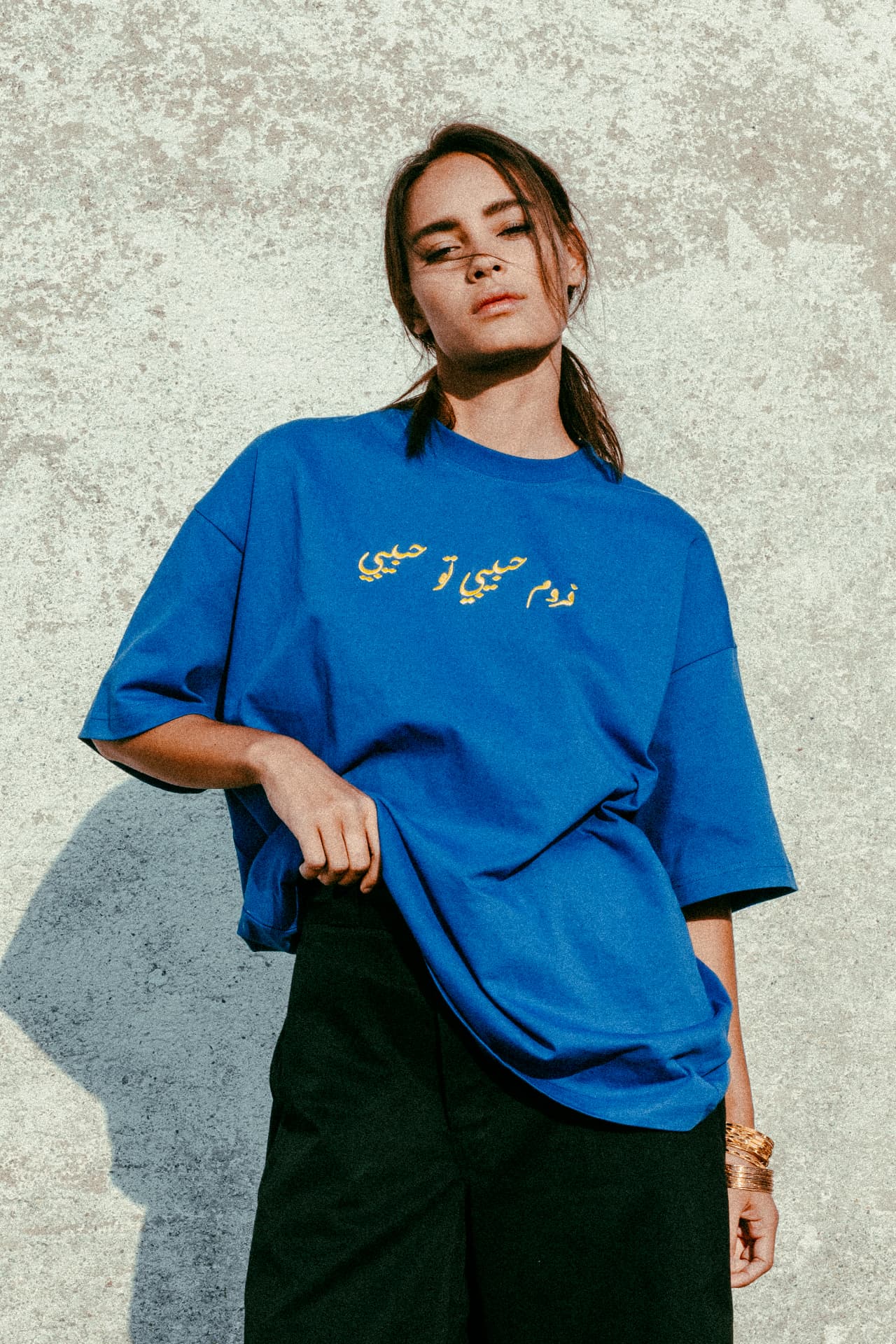 From Habibi to Habibi fashion photograph 10 — against a weathered wall