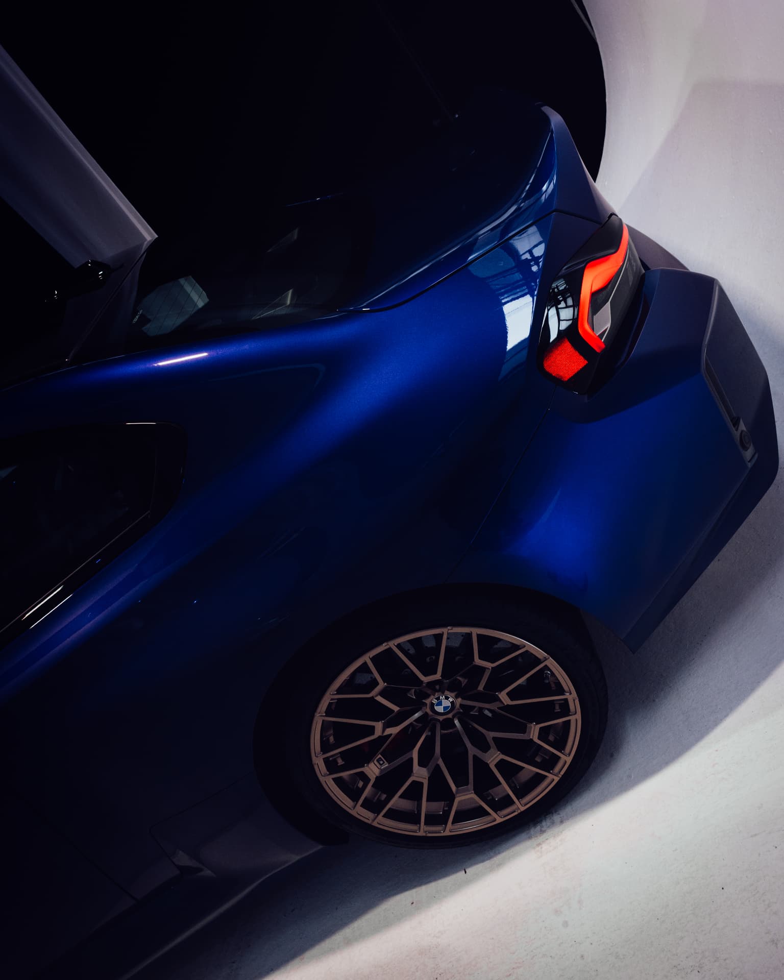 Rear view of THE M2 CS in deep blue with bronze alloy wheel at IAA 2025
