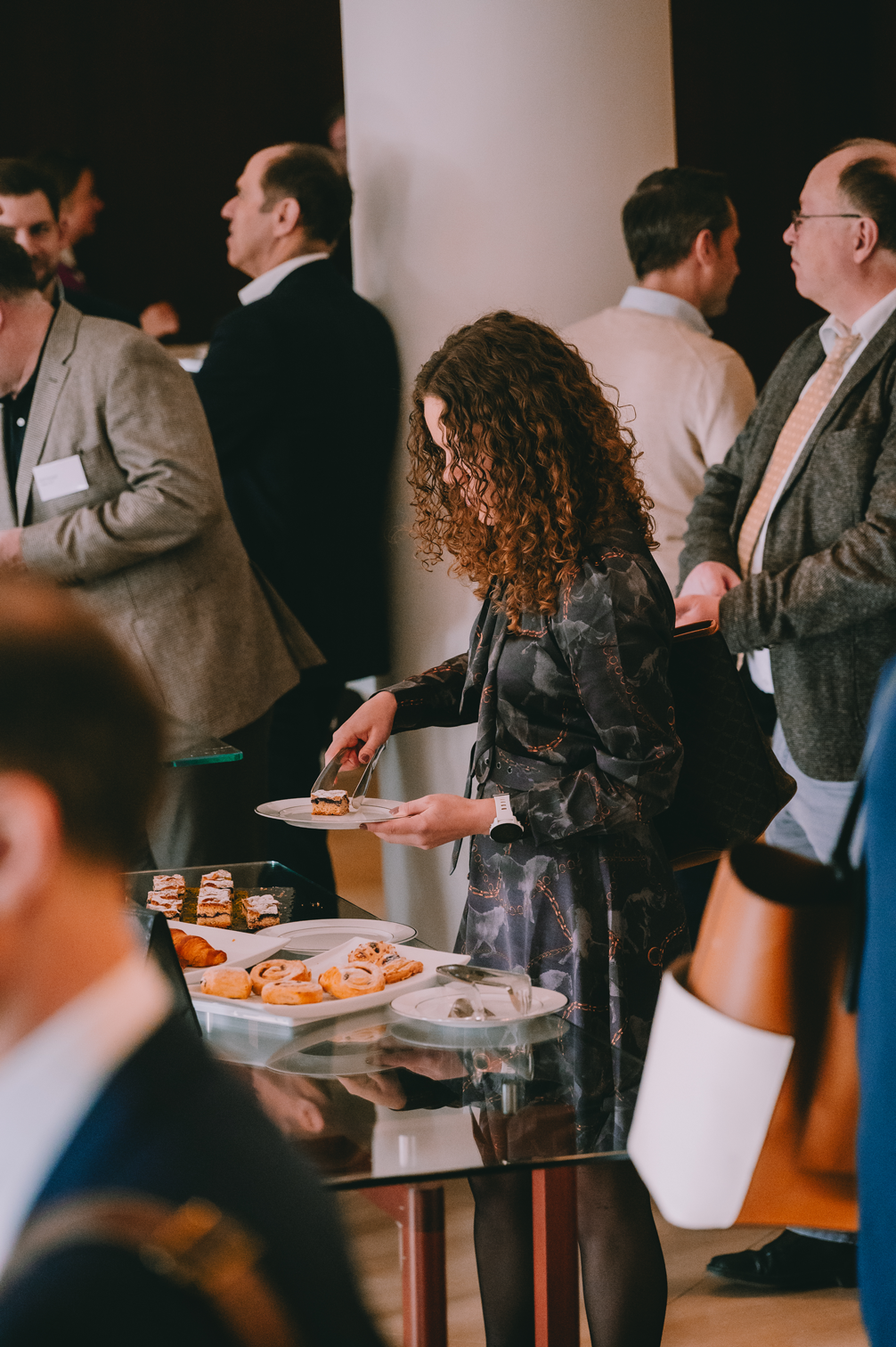 A NOERR Competition Day guest serving food at the buffet during a networking break