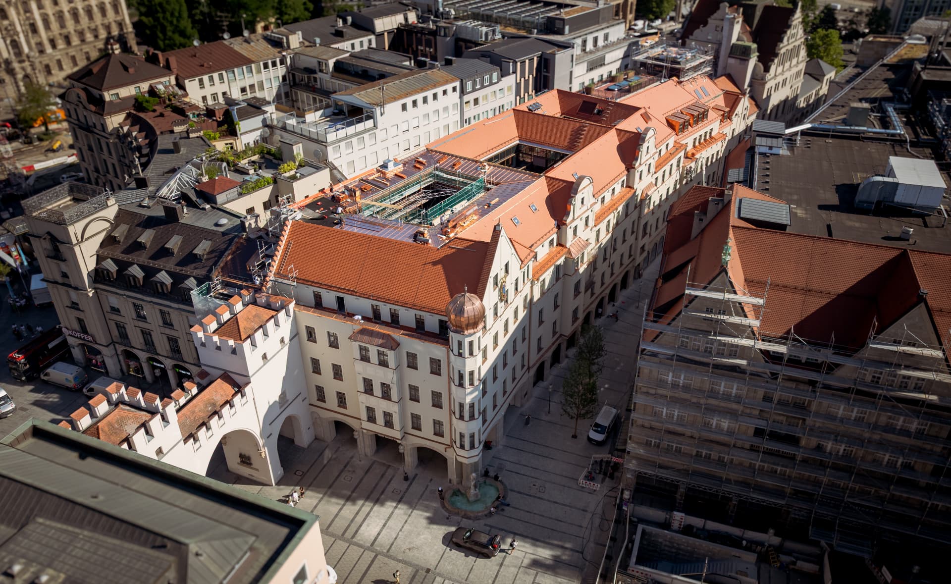 Aerial view of Herzog Max and the surrounding old-town rooftops along Herzog-Wilhelm-Straße, Munich