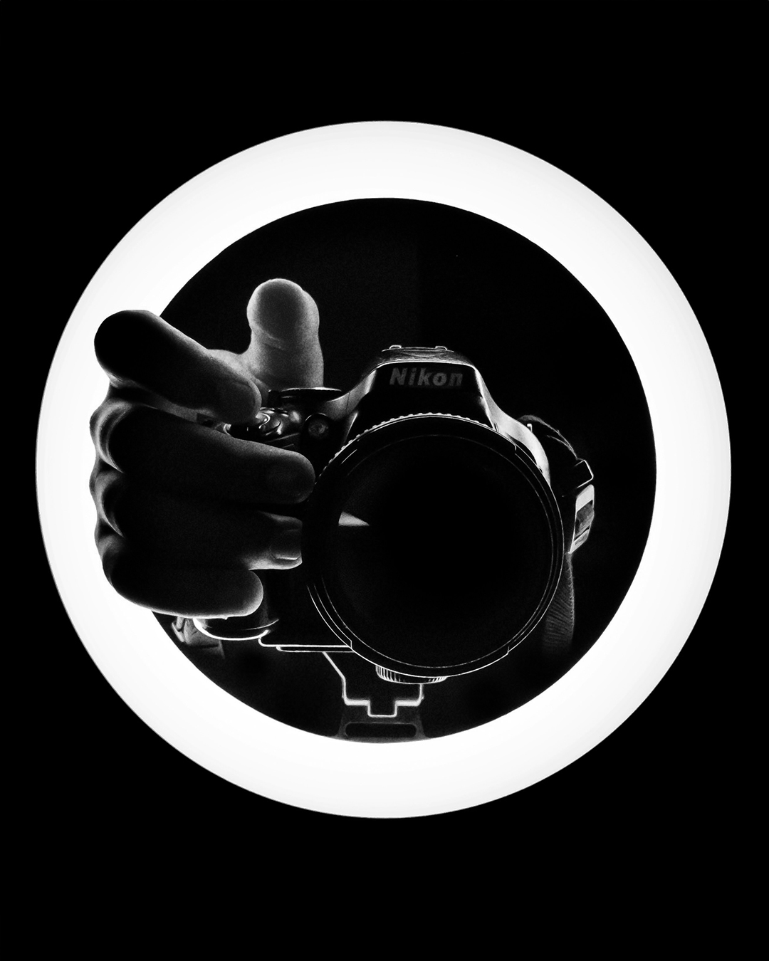 Black-and-white camera shot through a ring light