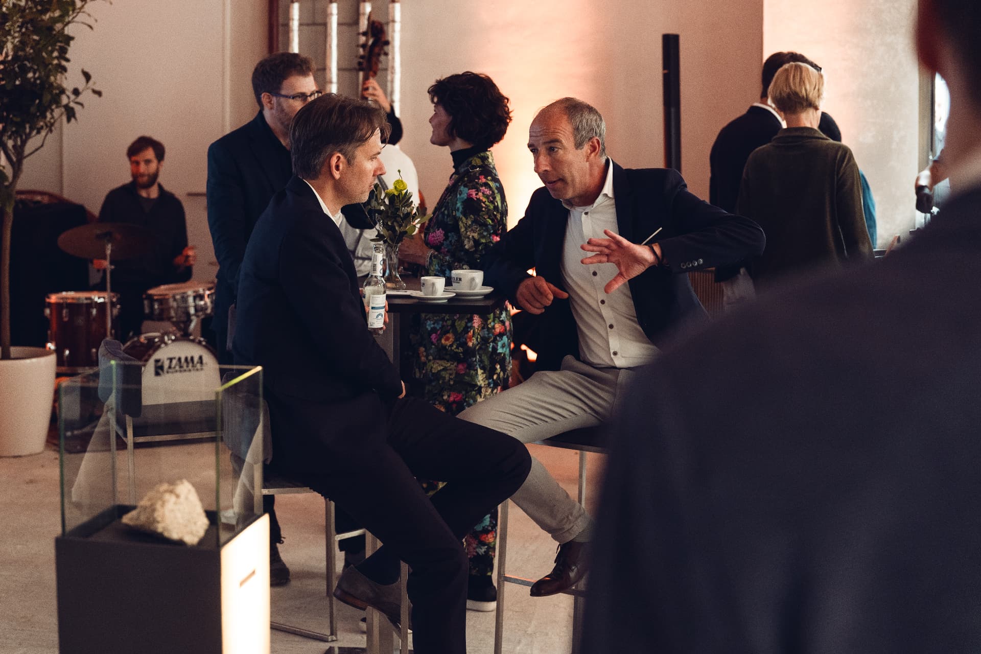 Conversation between guests at the café tables during the Herzog Max opening reception