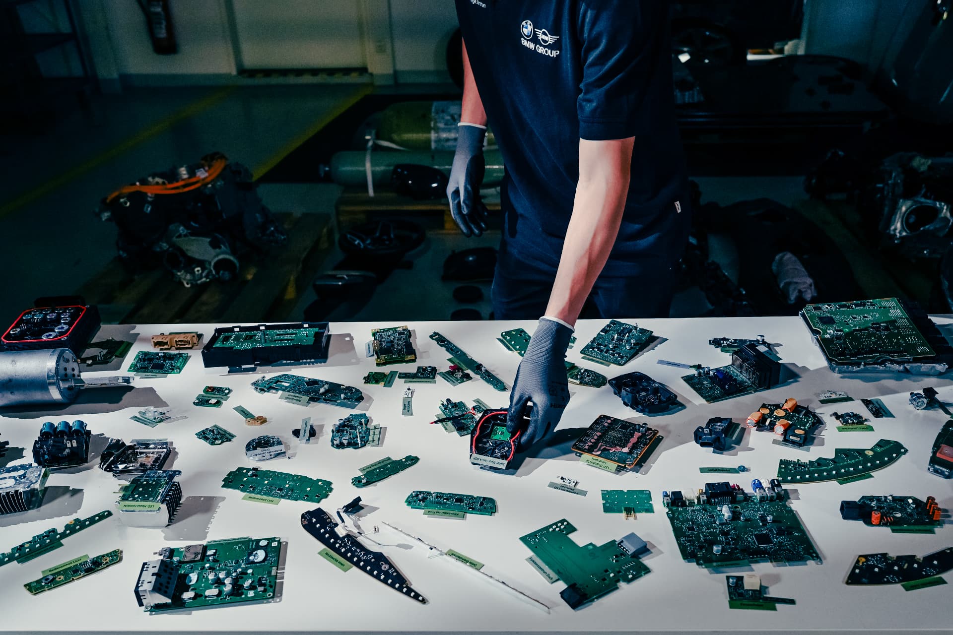 BMW Group technician sorting disassembled vehicle electronics at the Recycling & Demontage Zentrum
