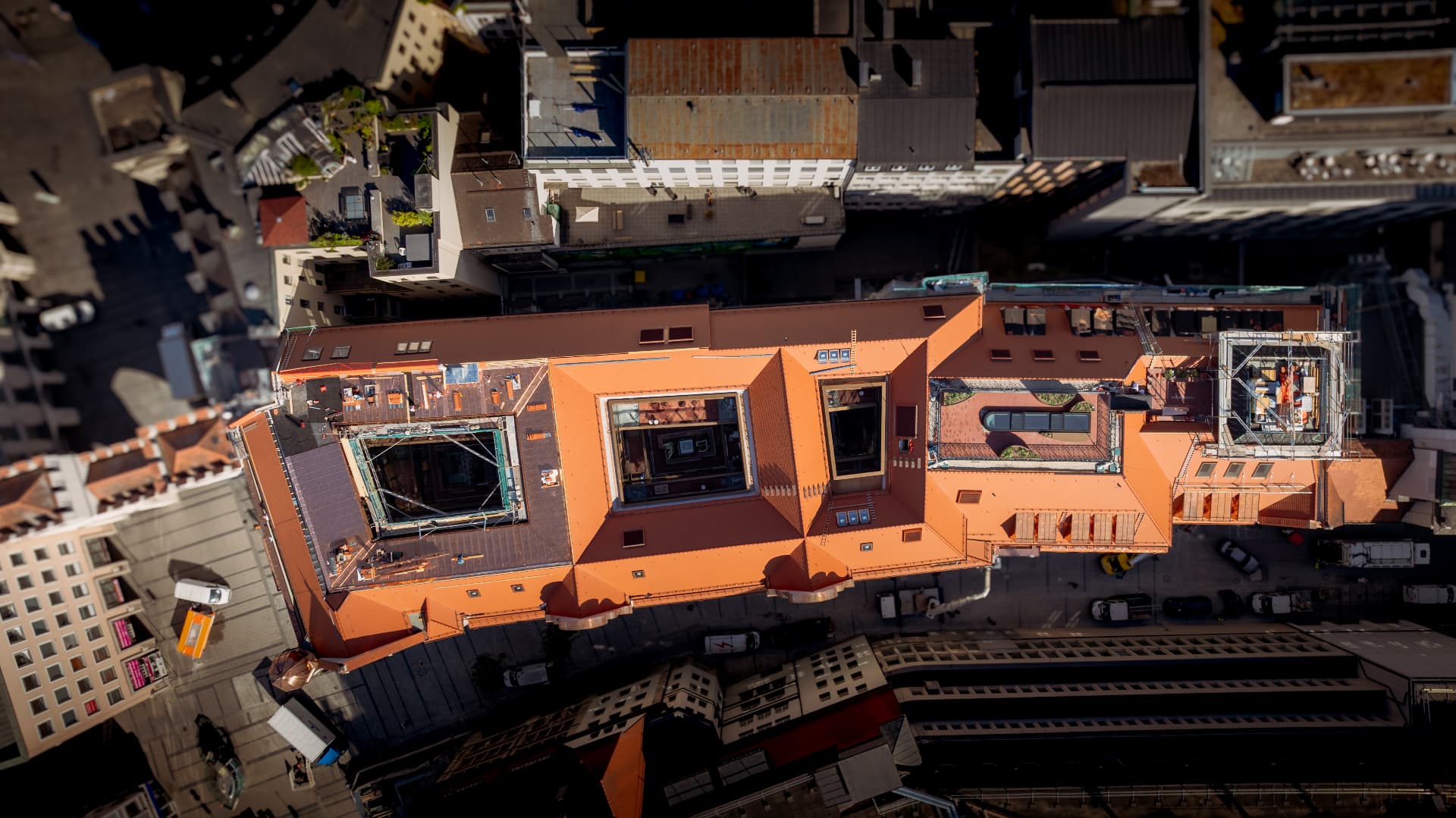 Directly overhead aerial view of the Herzog Max roofscape with its courtyards and copper detailing